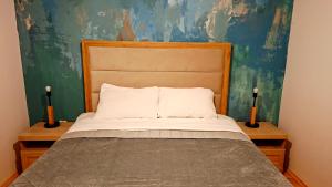 a bedroom with a bed with two candles on tables at Lumer in Kolašin
