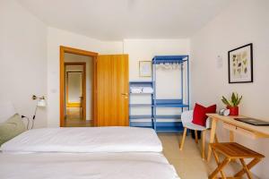 a bedroom with a bed and a desk and a deskablish at Casa Pradiei Dolomiti View in Cavareno