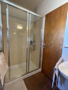 a shower stall in a bathroom with a sink at The Barns Low Stott Park near Lake Windermere in Ulverston