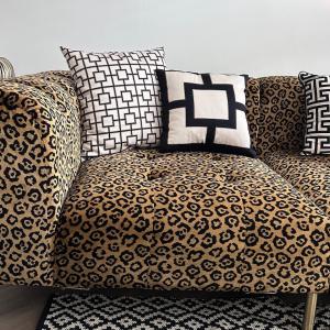 a couch with black and white pillows on it at No 6 Harrogate Luxury Boutique Home in Harrogate