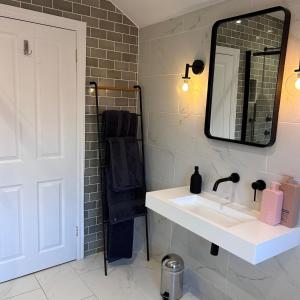 a bathroom with a sink and a mirror at No 6 Harrogate Luxury Boutique Home in Harrogate