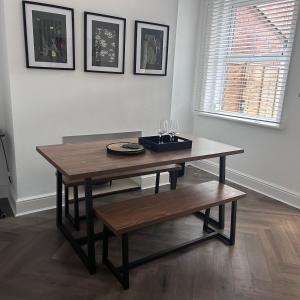a wooden table with a bench in a room at No 6 Harrogate Luxury Boutique Home in Harrogate +11 photos