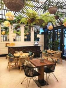 a restaurant with tables and chairs and plants at Mc Donalds Hotel Apartment Nizami Street in Baku