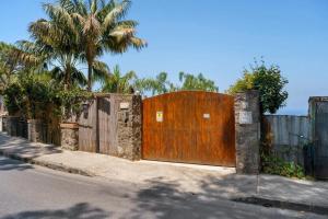 a large wooden door on a fence on a street at Villa Panorama Isola di Ischia in Ischia