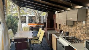 an outdoor kitchen with a table and a stove at Vila Ale in Mamaia Sat/Năvodari