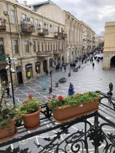 a city street with people walking on the street at Mc Donalds Hotel Apartment Nizami Street in Baku