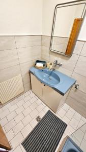 a bathroom with a sink and a mirror at Grazer Nest - Cozy apartment in Graz in Graz +22 photos