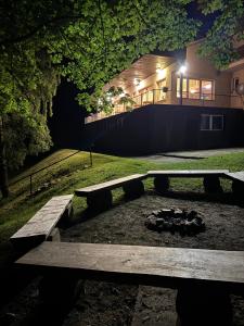 a picnic table in front of a building at night at Hotel Horní Pramen in Špindlerův Mlýn