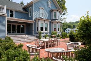 a house with a patio with a table and chairs at The Kent Collection - The Victorian in Kent