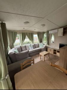 a living room with a couch and a table at VICTORY-CELESTE 4 Places in Saint-Jean-de-Monts