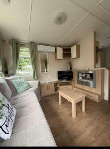 a living room with a couch and a table at VICTORY-CELESTE 4 Places in Saint-Jean-de-Monts