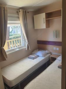 a small bedroom with a bed and a window at VICTORY-CELESTE 4 Places in Saint-Jean-de-Monts +25 photos