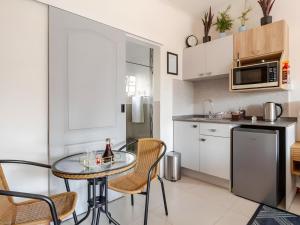 a kitchen with a table and chairs in a room at Amalfi Place in Pretoria