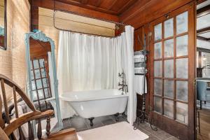 a bathroom with a bath tub and a window at Oak Suite in Berkeley