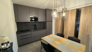 a kitchen with a table with chairs and a microwave at SECRET Lodge in Pianello Del Lario