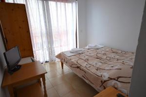 Ένα ή περισσότερα κρεβάτια σε δωμάτιο στο Guest House Olimpia