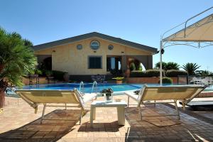 a house with a pool and two chairs and a table at B&B Casa di Giò Luxury Resort in Lanuvio