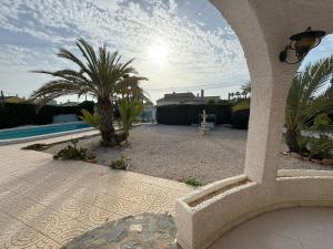 a view of a backyard with a pool and palm trees at Ideal pool chalet WBR in La Mata