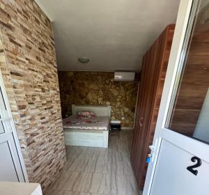 a small room with a bed in a brick wall at Vila Vlad in 2 Mai +12 photos
