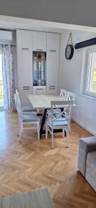a dining table and chairs in a living room at Apartman Nadja2 in Tivat +5 photos
