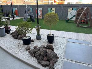 a playground with plants and a rock garden at Luxury Tower Top Floor Apartment in Arequipa