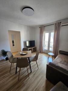 a living room with a table and a couch at Lendas Apartments & Rooms in Baška Voda