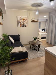 a living room with a couch and a table at Luxury Tower Top Floor Apartment 