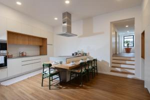 a kitchen with a dining room table and chairs at Quinta do Rosário in Lagoa
