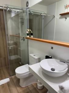 a bathroom with a toilet and a sink and a shower at Luxury Tower Top Floor Apartment  +18 photos