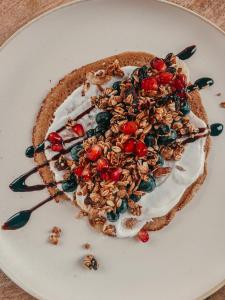 a dessert with whipped cream and berries on a plate at RetreatBoat Ibiza in Lith +27 photos