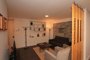 a living room with a couch and a table at Guest house Santa Maria in Funchal
