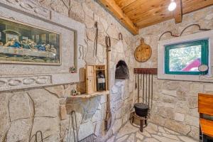 a room with a stone wall in a house at Villa Lara, Family Retreat with Sea View & Pool in Sveti Filip i Jakov