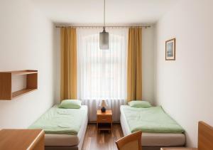 two beds in a room with a window at Babel Hostel, Dworzec PKP, Rynek in Wrocław