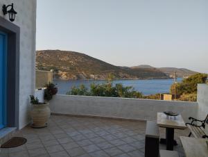 a balcony with a view of the water at Glaros Studios Agriolivadi Patmos in Patmos +8 photos