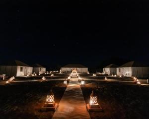 Una fila de luces en un campo por la noche en Africa Luxury Camp, en Merzouga