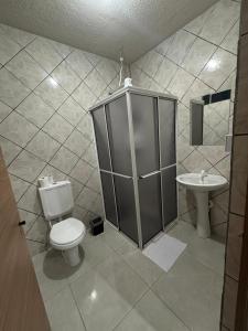 a bathroom with a toilet and a sink at Oberon Business Hotel in Castro +36 photos