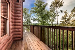 a wooden deck on a cabin with a window at Rustic Escape Cabin w Private Hot Tub & Grill in Pigeon Forge