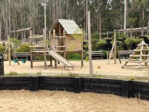 a playground with a slide and a play structure at Departamento Playa Las Cruces LagunaMar 3D2B con KYAK in Las Cruces