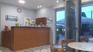 a kitchen with a counter and a table with chairs at Katerina Lefkada in Vasiliki