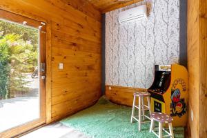 a room with a chair and a guitar at Relaxing Getaway at Smoky Arcade & Resort Pool in Pigeon Forge