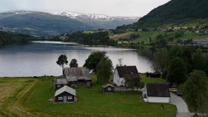 an aerial view of a house on the shore of a lake at Simple Lakeside Anex - By the Water's Edge in Vossevangen