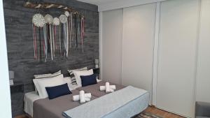 a bedroom with two beds with white and blue pillows at Casa 4P - House4People - Alojamento Local in Penacova