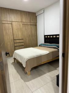 a bedroom with two beds and a sliding door at Departamento con Rooftop en Mezcales in Mezcales