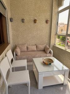 a living room with a couch and a table and chairs at Firras Mdiq in M'diq +6 photos