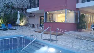 a house with a swimming pool next to a building at Katerina Lefkada in Vasiliki