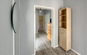 a hallway with a mirror and a closet at Amazing Home In Karlino in Karlino