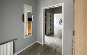 a room with a hallway with a mirror and a door at Amazing Home In Karlino in Karlino