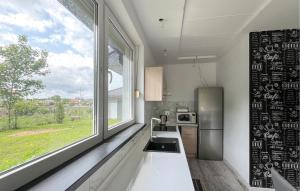 a kitchen with a counter and a large window at Amazing Home In Karlino in Karlino