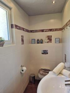 a white bathroom with a sink and a window at Ferienhaus am Thüringer Meer in Bad Lobenstein +26 photos