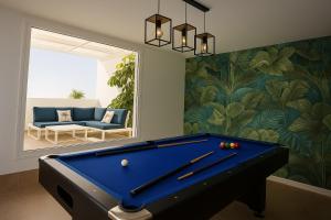 a pool table in a living room with a mirror at Villa Ocean 8 by Dreaming Lanzarote Villas in Yaiza
